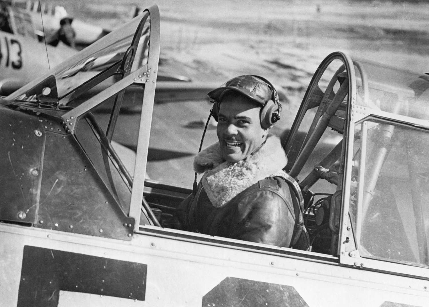a black and white photo of General Benjamin O Davis Jr in a plane cockpit