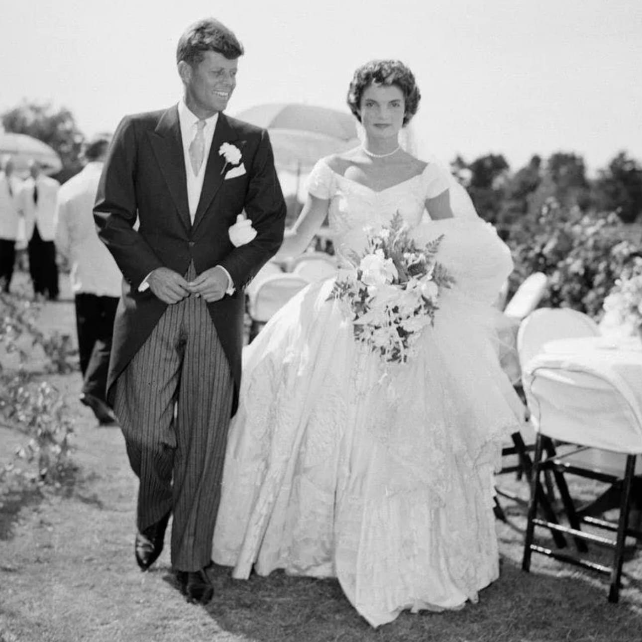 JFK and Jackie Kennedy at their wedding, Jackie is wearing one of Ann Lowe's dresses. 