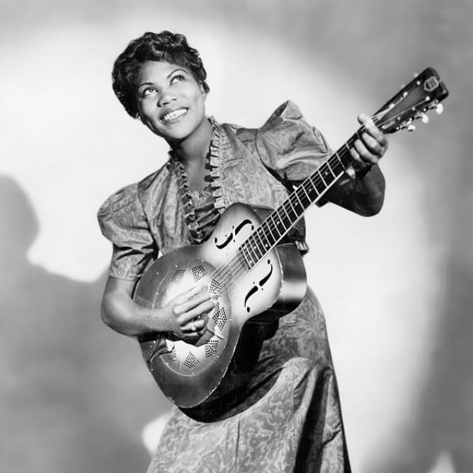 A photograph of legendary music artist Sister Rosetta Tharpe and her electric guitar