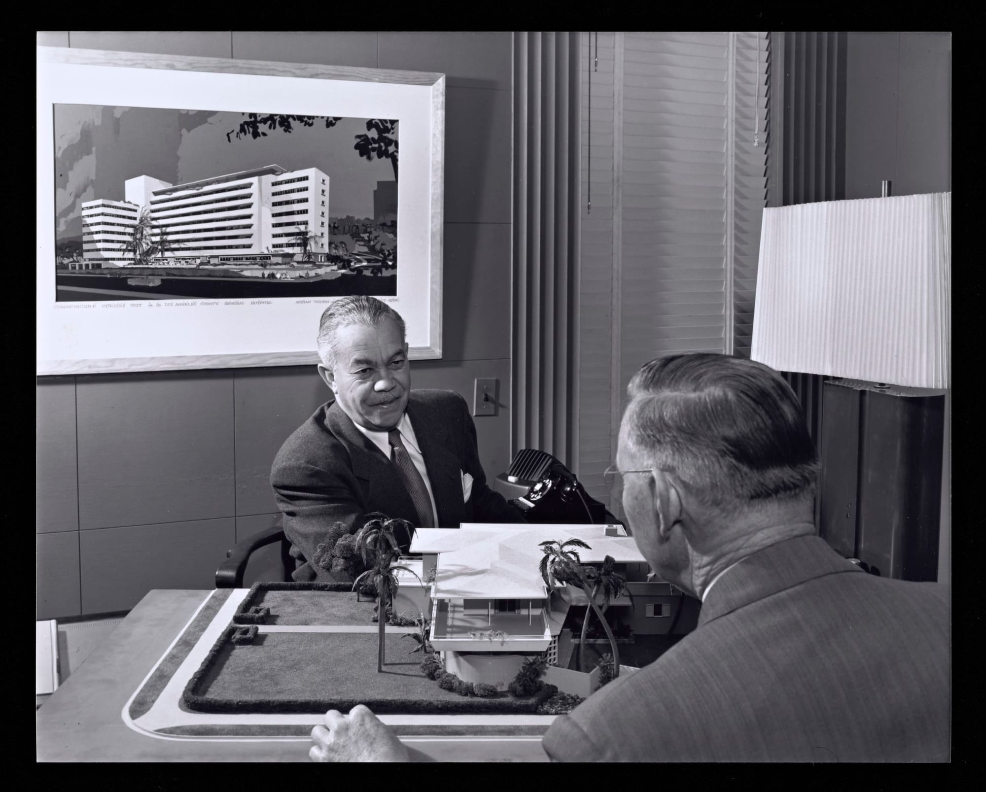 Paul R. Williams in office with a client (1952) Photography by Julius Shulman, Gelatin Silver Print, © J. Paul Getty Trust.