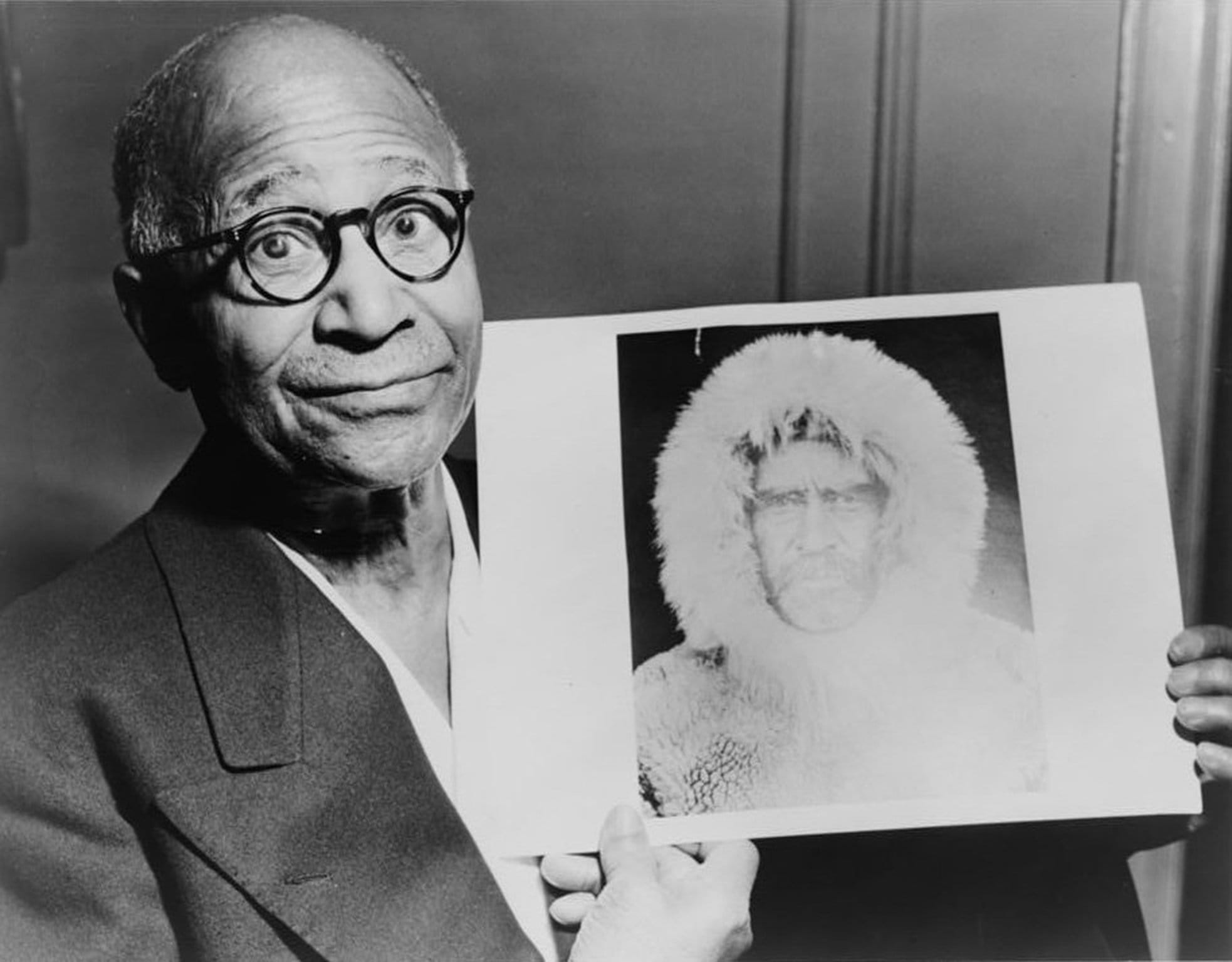 Matthew Henson holding a picture of Peary