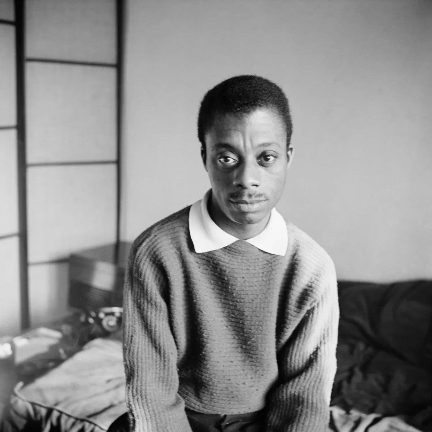a black and white photo of young james baldwin 