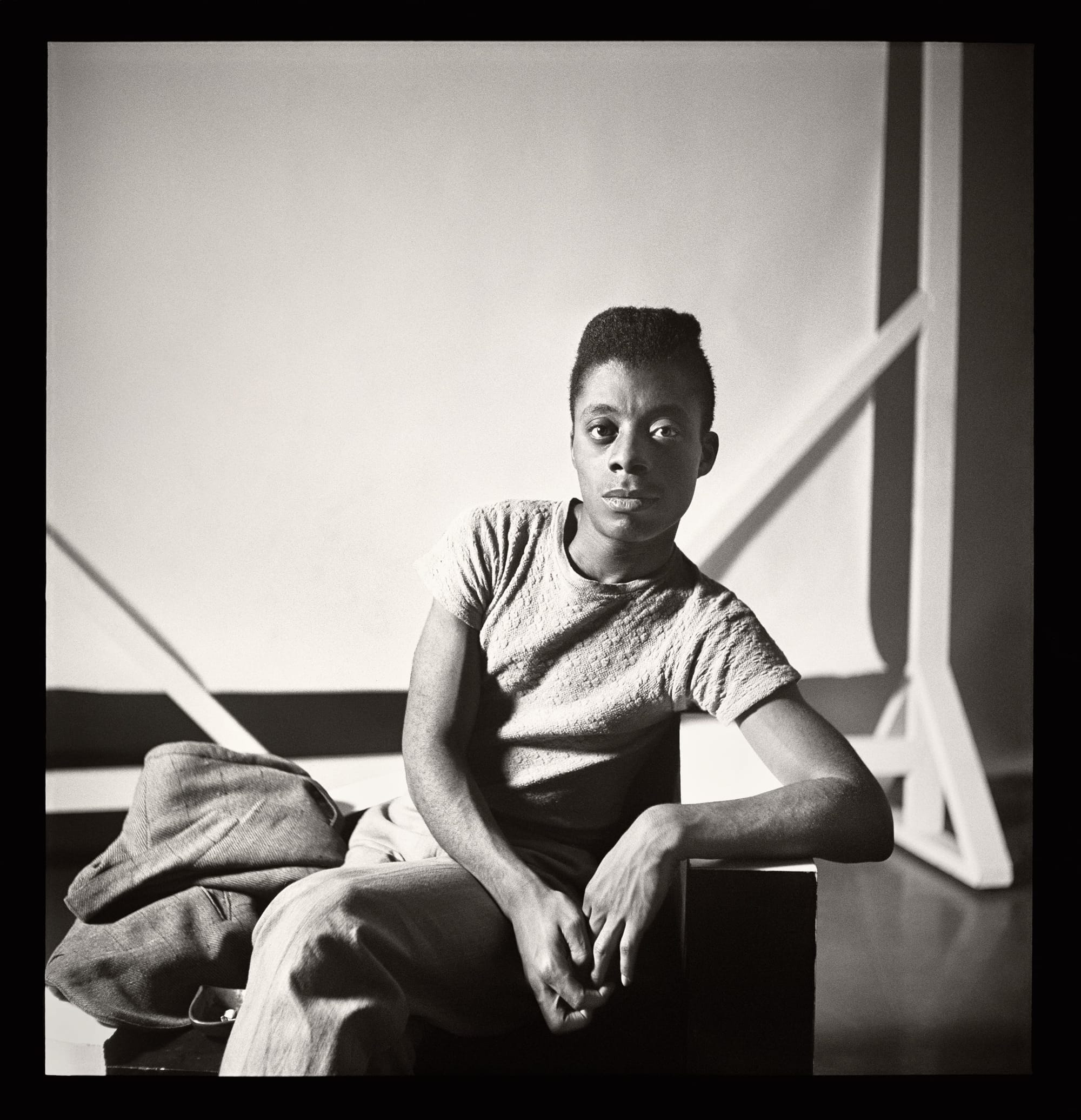 a black and white photo of young James Baldwin