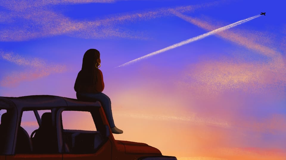Alleanna sits on a red Jeep wrangler and watches a plane fly across the sunset sky.